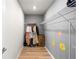 Walk-in closet with metal shelving, wood floors, and neutral walls with flower decals at 2130 Bur Oak Blvd, St Cloud, FL 34771
