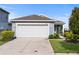 Charming one-story home featuring a two-car garage, well-maintained landscaping, and a welcoming facade at 2130 Bur Oak Blvd, St Cloud, FL 34771