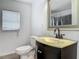 Modern bathroom featuring stylish vanity, mirror, and toilet at 2203 Beatrice Dr, Orlando, FL 32810