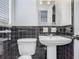 A classic-styled bathroom with black tile and a pedestal sink at 2203 Beatrice Dr, Orlando, FL 32810