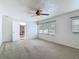Bright, carpeted bedroom with large windows and a ceiling fan at 2203 Beatrice Dr, Orlando, FL 32810