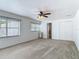 Spacious carpeted bedroom with natural light and access to a closet and bathroom at 2203 Beatrice Dr, Orlando, FL 32810