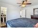 This is a bedroom with a ceiling fan, closet, and a view of the bathroom at 2203 Beatrice Dr, Orlando, FL 32810