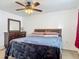Cozy bedroom featuring a ceiling fan, dresser, and comfortable bedding at 2203 Beatrice Dr, Orlando, FL 32810