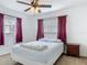 Comfortable bedroom featuring a bed, side table, and natural light from windows at 2203 Beatrice Dr, Orlando, FL 32810