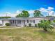 Charming single-story home with a well-manicured front yard and modern solar panels at 2203 Beatrice Dr, Orlando, FL 32810