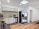 Efficient kitchen featuring stainless steel appliances, mosaic backsplash, and ample counter space at 2203 Beatrice Dr, Orlando, FL 32810