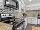 Close-up view of the kitchen featuring modern appliances and granite countertops at 2203 Beatrice Dr, Orlando, FL 32810