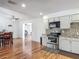 Well-lit kitchen with white cabinets, modern appliances, and seamless transition to dining area at 2203 Beatrice Dr, Orlando, FL 32810