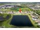 An elevated view of a large community with a beautiful pond nearby, complete with a soccer field at 2332 Andrews Valley Dr, Kissimmee, FL 34758