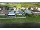 Aerial view showcasing a well-maintained property with white picket fence, lush lawn and lake view at 2332 Andrews Valley Dr, Kissimmee, FL 34758