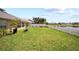 Spacious backyard with grass, lake and a white picket fence at 2332 Andrews Valley Dr, Kissimmee, FL 34758