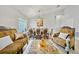 Formal dining room featuring protected furniture, chandelier, and ample space for entertaining guests at 2332 Andrews Valley Dr, Kissimmee, FL 34758