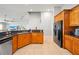 Spacious kitchen featuring tile floors, modern appliances, granite countertops, and wooden cabinets at 2332 Andrews Valley Dr, Kissimmee, FL 34758