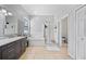 Luxurious main bathroom with double sink vanity, glass-enclosed shower, and soaking tub at 2332 Andrews Valley Dr, Kissimmee, FL 34758