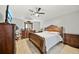 Spacious main bedroom featuring luxurious wooden furniture, neutral walls, and tile flooring at 2332 Andrews Valley Dr, Kissimmee, FL 34758