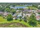 An expansive aerial view of the neighborhood including mature trees, community ponds, and lush landscaping at 2391 Piedmont Lakes Blvd, Apopka, FL 32703