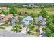 An aerial view of the neighborhood shows mature trees, community ponds, and lush landscaping at 2391 Piedmont Lakes Blvd, Apopka, FL 32703