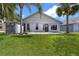 Backyard view showing a well-maintained lawn and the back of the house and storage shed at 2391 Piedmont Lakes Blvd, Apopka, FL 32703