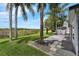 Backyard featuring lush green grass, palm trees, a storage shed, and views of the greenbelt at 2391 Piedmont Lakes Blvd, Apopka, FL 32703
