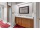 Bathroom with a double sink vanity, large mirror, and walk-in shower, offering functionality and comfort at 2391 Piedmont Lakes Blvd, Apopka, FL 32703