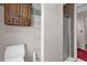 Bathroom with a toilet, storage shelves, and a glass-enclosed shower, designed for efficient use of space at 2391 Piedmont Lakes Blvd, Apopka, FL 32703