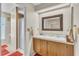 Bright bathroom featuring double sinks, a vanity with cabinets, and a glass door shower at 2391 Piedmont Lakes Blvd, Apopka, FL 32703