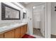 Bathroom featuring a double sink vanity, a large mirror, and an entrance to a walk-in closet at 2391 Piedmont Lakes Blvd, Apopka, FL 32703