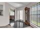 Elegant foyer featuring tile flooring, front door with patterned glass, grandfather clock, and view into other rooms at 2391 Piedmont Lakes Blvd, Apopka, FL 32703