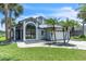 Charming single-Gathering home featuring a metal roof, a two-car garage and lush tropical landscaping at 2391 Piedmont Lakes Blvd, Apopka, FL 32703
