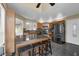 Open eat-in kitchen with breakfast bar, stainless steel appliances and wooden cabinets at 2391 Piedmont Lakes Blvd, Apopka, FL 32703