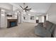Spacious living room with fireplace, vaulted ceilings, ceiling fan, and access to other rooms in the home at 2391 Piedmont Lakes Blvd, Apopka, FL 32703