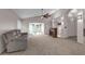 Spacious living room with fireplace, vaulted ceilings, ceiling fan, and access to other rooms in the home at 2391 Piedmont Lakes Blvd, Apopka, FL 32703