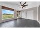 Bright living room featuring tile floors, large windows with views, and double closets at 2391 Piedmont Lakes Blvd, Apopka, FL 32703