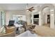 Bright living room featuring vaulted ceilings, a fan and a cozy fireplace, creating a warm atmosphere at 2391 Piedmont Lakes Blvd, Apopka, FL 32703