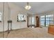 Bright living room with a large front window, glass front door, and traditional grandfather clock at 2391 Piedmont Lakes Blvd, Apopka, FL 32703