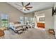 Spacious main bedroom with large windows, ceiling fan, and an ensuite bathroom at 2391 Piedmont Lakes Blvd, Apopka, FL 32703