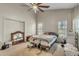 Cozy main bedroom featuring a ceiling fan, natural light, and an ensuite bathroom at 2391 Piedmont Lakes Blvd, Apopka, FL 32703
