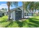 Backyard with a storage shed surrounded by palm trees and green grass at 2391 Piedmont Lakes Blvd, Apopka, FL 32703
