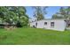 Lush backyard featuring a well-maintained lawn and a charming seating area at 2525 Lafayette Ave, Winter Park, FL 32789