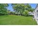 Expansive backyard showcasing a lush green lawn and a relaxing outdoor seating arrangement at 2525 Lafayette Ave, Winter Park, FL 32789