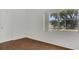 Bedroom featuring hardwood floors, neutral walls, and a large window offering outdoor views at 2525 Lafayette Ave, Winter Park, FL 32789