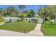 Charming single-story home with a well-manicured front lawn, a walkway, and mature landscaping at 2525 Lafayette Ave, Winter Park, FL 32789