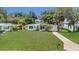 Charming single-story home with a well-maintained lawn and mature trees offering curb appeal at 2525 Lafayette Ave, Winter Park, FL 32789