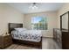 Inviting bedroom with wood-look flooring, a ceiling fan, and a view from the window at 2550 N Alafaya Trl # 2304, Orlando, FL 32826