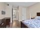 Spacious bedroom with wood-look flooring, closet, and adjacent bathroom at 2550 N Alafaya Trl # 2304, Orlando, FL 32826