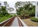 Scenic boardwalk winding through lush greenery, offering serene water views at 2550 N Alafaya Trl # 2304, Orlando, FL 32826