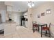 View of the dining area with adjacent kitchen featuring neutral paint and tile floors at 2550 N Alafaya Trl # 2304, Orlando, FL 32826