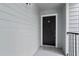 View of the front door of unit 1204 featuring a digital lock and a welcome mat at 2550 N Alafaya Trl # 2304, Orlando, FL 32826