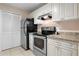 The kitchen features granite countertops, stainless steel appliances, and white cabinetry at 2550 N Alafaya Trl # 2304, Orlando, FL 32826